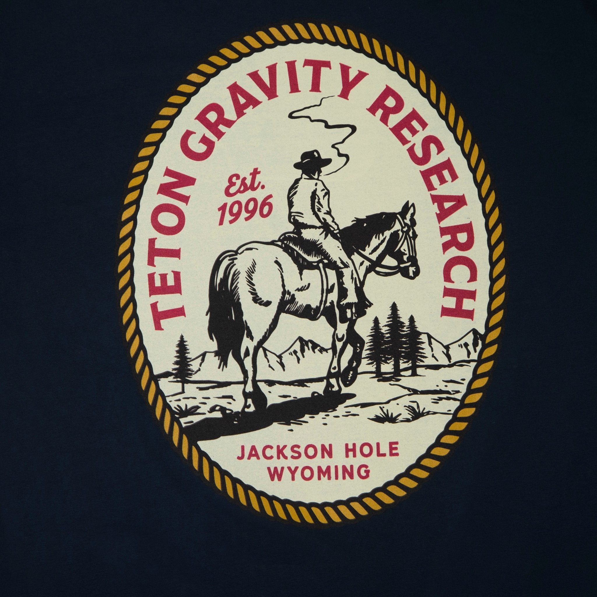 black t-shirt with lonesome cowboy graphic on back of t-shirt. Graphic shows a cowboy on a horse with est. 1996, Jackson hole Wyoming letter on it.